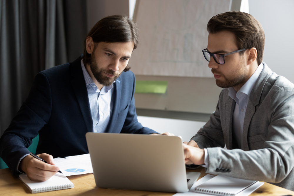 IT service contract being reviewed by two men