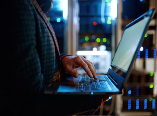  Man looking up IT Service Provider on a laptop